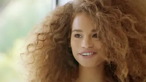 Teenage black with wavy hair is railing a meaty stiffy on the sofa